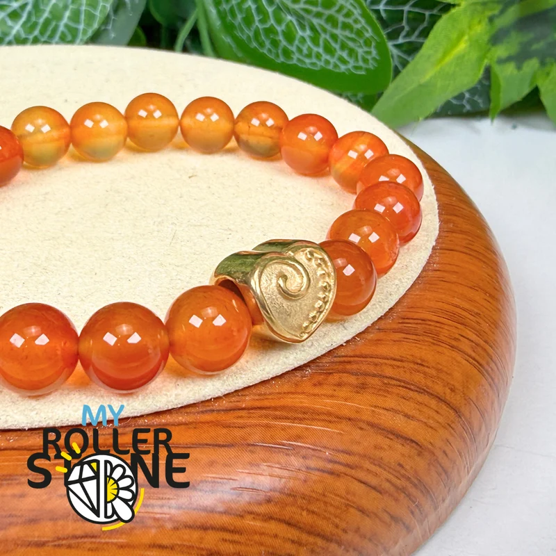 Perla en forma de corazón con espiral dorada